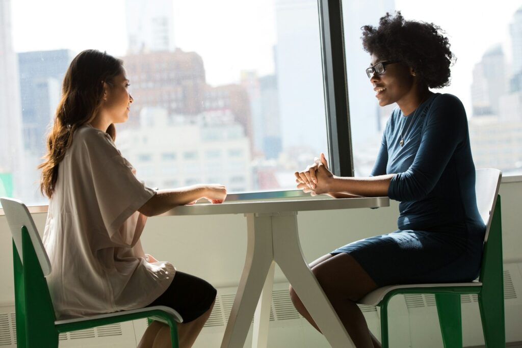 Lead FSO - Homepage 25 Franchise candidate and advisor talking across a table in an office with city views